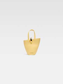 Асимметричная мини-сумка-ведро Jacquemus The small Bambola, светло-желтый 243ba389-3173-210 | light yellow